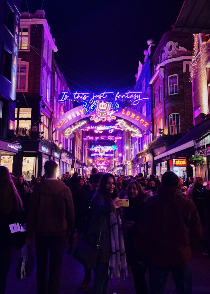 Night time scene in the busy Carnaby Street in Soho London. Soho is a popular area among people who are new in London