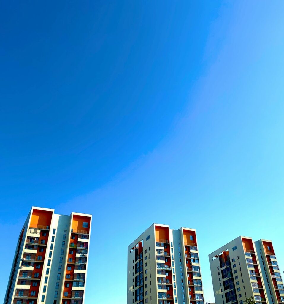 white and green concrete building under blue sky during daytime