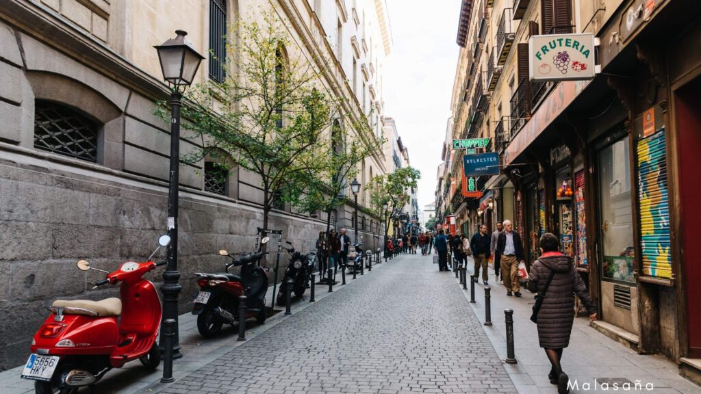 Vibrant Malasana neighborhood in Madrid, known for its lively student atmosphere, trendy cafes, and proximity to major universities.